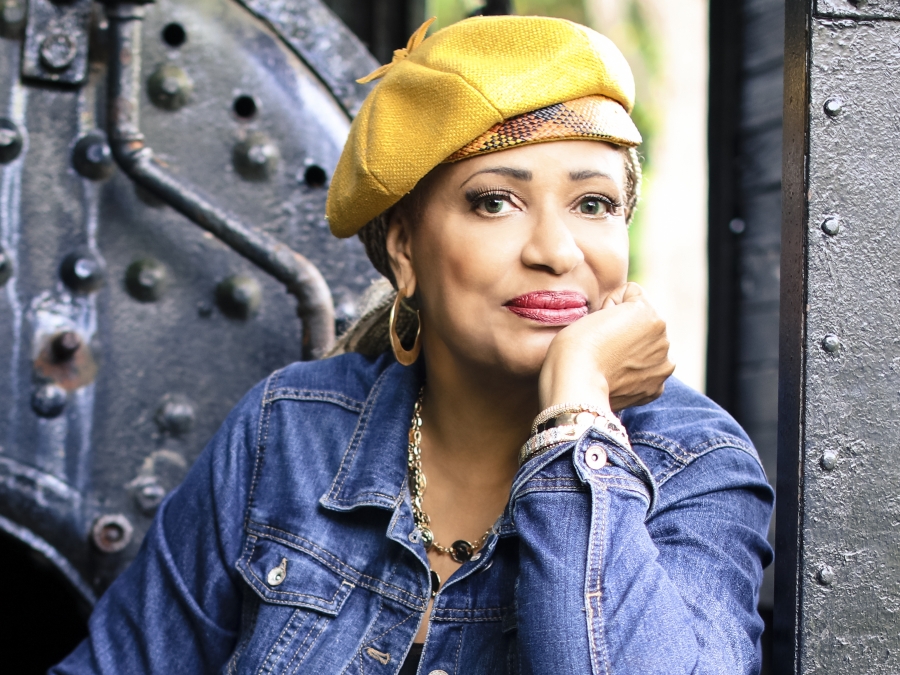 Vaneese Thomas ’74, H’14 wearing a yellow hat looking at the camera